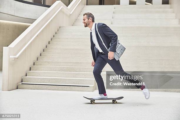 businesssman riding skateboard at staircase - look stock-fotos und bilder