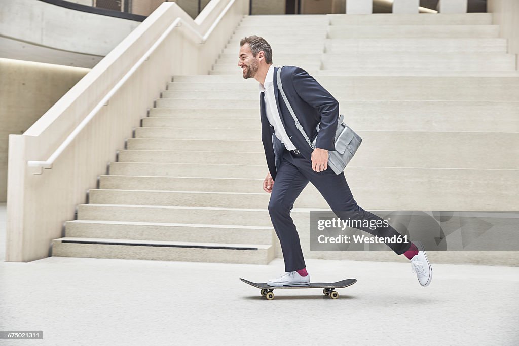 Businesssman riding skateboard at staircase