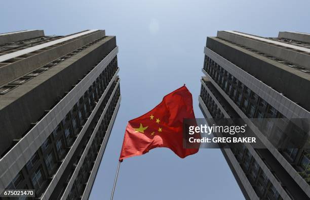 Chinese flag flies outside a residential compound in Beijing on April 30, 2017. - China has launched perhaps its most concerted push yet to clean up...