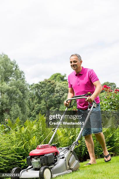 man lawnmowing - lawnmowing stock pictures, royalty-free photos & images