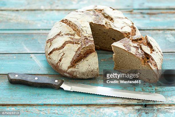 rustic rye bread on blue wood, knife - rye bread stock pictures, royalty-free photos & images