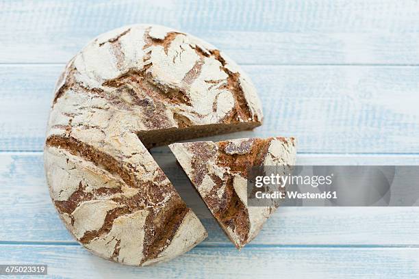 rustic rye bread on blue wood - rye bread stock pictures, royalty-free photos & images