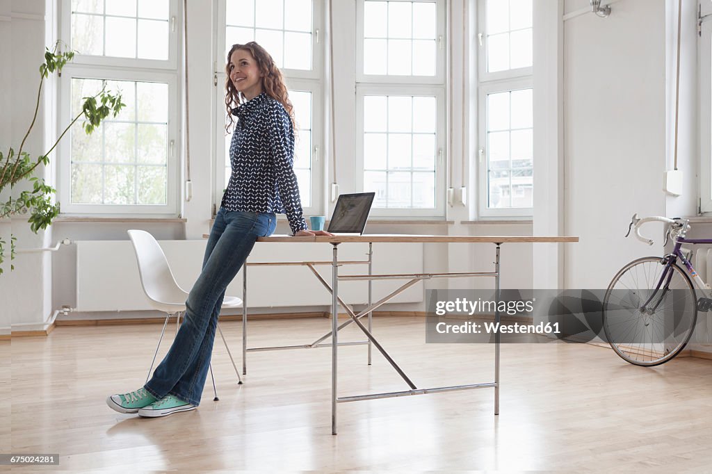 Smiling woman in sparse office