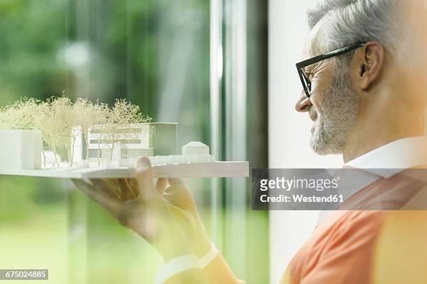 happy man looking at architectural model - architekturmodell stock-fotos und bilder