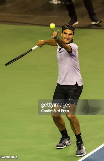 Roger Federer of Switzerland hits a serve to John Isner of the United States at the Match For Africa 4 exhibition match at KeyArena on April 29, 2017...