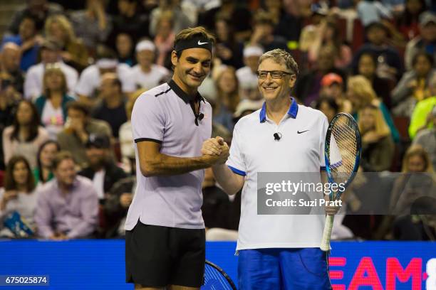 Roger Federer of Switzerland and Bill Gates shake hands at the Match For Africa 4 exhibition match at KeyArena on April 29, 2017 in Seattle,...