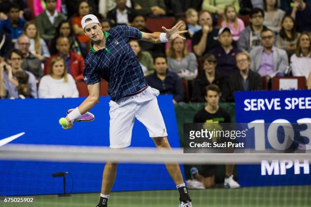 John Isner of the United States hits a serve against Roger Federer of Switzerland at the Match For Africa 4 exhibition match at KeyArena on April 29,...