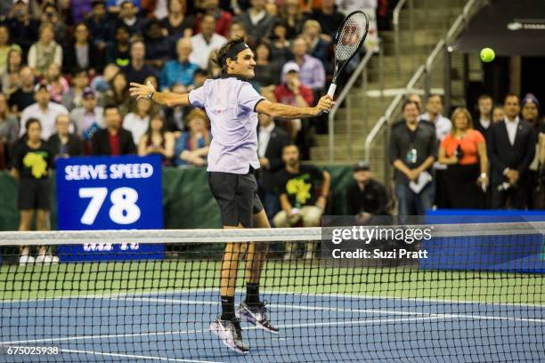 Roger Federer of Switzerland returns a serve against John Isner of the United States at the Match For Africa 4 exhibition match at KeyArena on April...