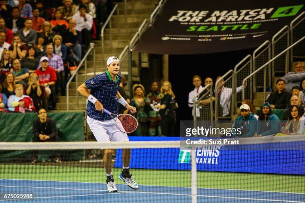 John Isner of the United States hits a serve against Roger Federer of Switzerland at the Match For Africa 4 exhibition match at KeyArena on April 29,...