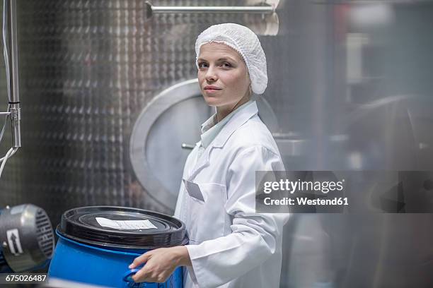 lab technician in pharmaceutical plant in front of tanks - hair net stock pictures, royalty-free photos & images