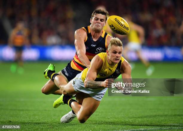 Brandon Ellis of the Tigers handballs during the round six AFL match between the Adelaide Crows and the Richmond Tigers at Adelaide Oval on April 30,...