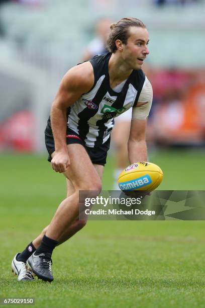 Tim Broomhead of the Magpies handballs during the round six AFL match between the Geelong Cats and the Collingwood Magpies at Melbourne Cricket...