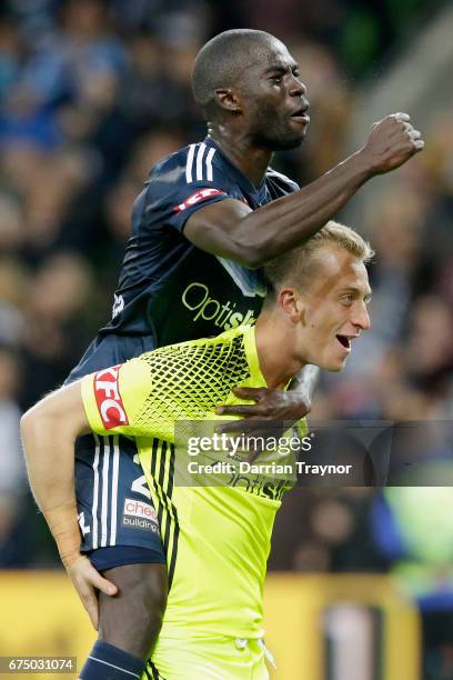 Jason Geria and Victory goalkeeper Lawrence Thomas celebrate their teams win during the A-League Semi Final match between Melbourne Victory and the...
