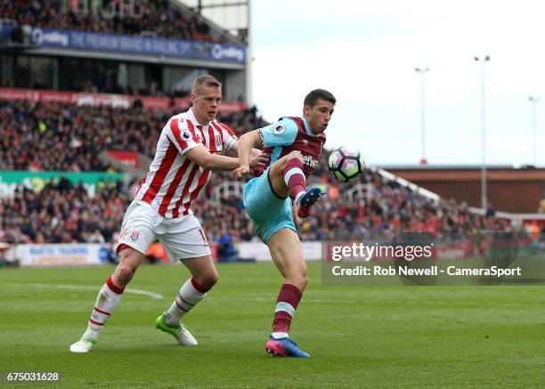 West Ham United's Jonathan Calleri and Stoke City's Ryan Shawcross during the Premier League match between Stoke City and West Ham United at Bet365...