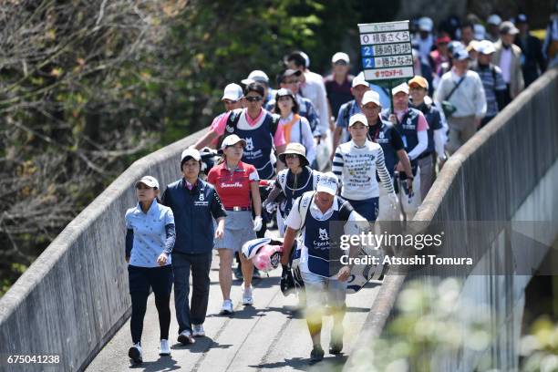 Sakura Yokomine of Japan and Minami Katsu of Japan walk on the bridge during the final round of the CyberAgent Ladies Golf Tournament at the Grand...