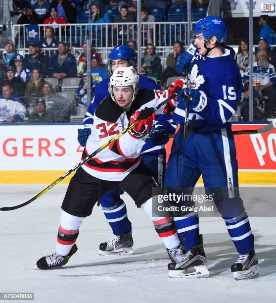 Blake Speers of the Albany Devils battles with Sergey Kalinin and Rinat Vailiev of the Toronto Marlies during game 3 action in the Division Semifinal...