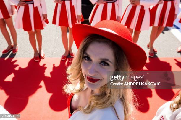 Grid girl poses for a photographer ahead of the Formula One Russian Grand Prix at the Sochi Autodrom circuit in Sochi on April 30, 2017. / AFP PHOTO...