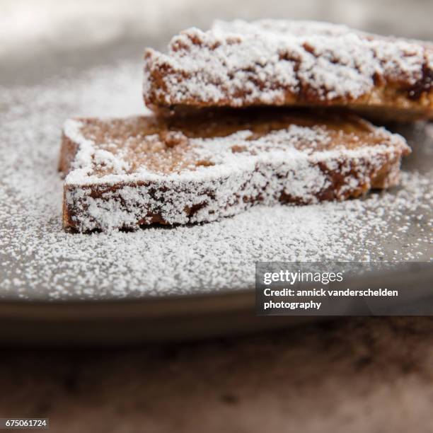 icing sugar on bread pudding slices. - baking bread tin stock pictures, royalty-free photos & images