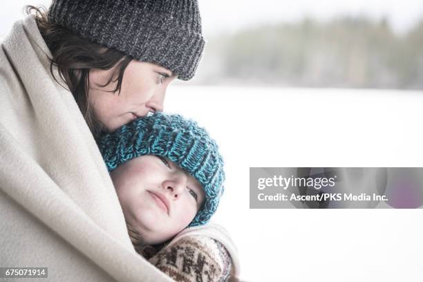 mother and daughter huddle at roadside, with belongings - homeless child stock-fotos und bilder