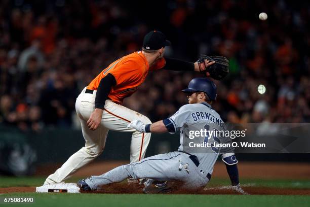 Cory Spangenberg of the San Diego Padres slides into third base ahead of a throw to Conor Gillaspie of the San Francisco Giants during the fifth...