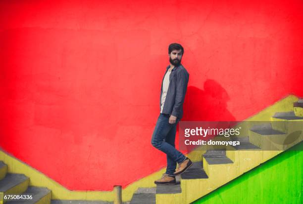 handsome man going down the stairs - guy looking down stock pictures, royalty-free photos & images