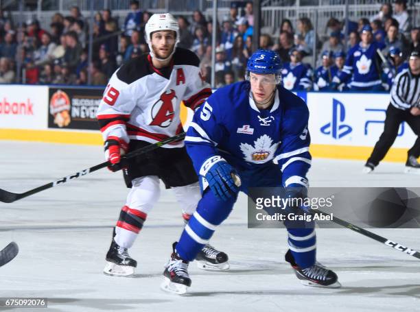 Steven Oleksy of the Toronto Marlies skates up ice against Carter Camper of the Albany Devils during game 4 action in the Division Semifinal of the...