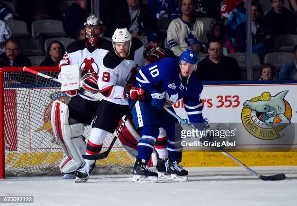 Cal O"u2019Reilly of the Toronto Marlies battles in the crease with Joshua Jacobs and goalie Mackenzie Blackwood of the Albany Devils during game 4...