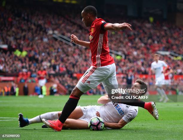 Swansea City's Argentinian defender Federico Fernandez blocks the pull-back from Manchester United's French striker Anthony Martial during the...