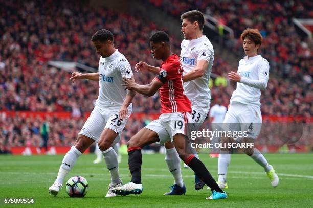 Swansea City's English defender Kyle Naughton , Swansea City's South Korean midfielder Ki Sung-Yueng and Swansea City's Argentinian defender Federico...