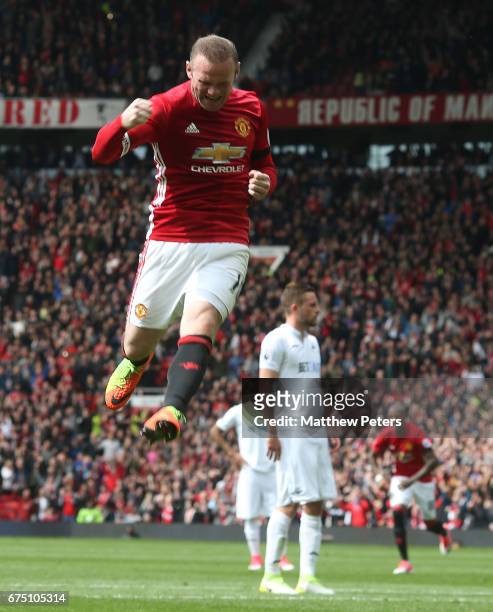Wayne Rooney of Manchester United celebrates scoring their first goal during the Premier League match between Manchester United and Swansea City at...