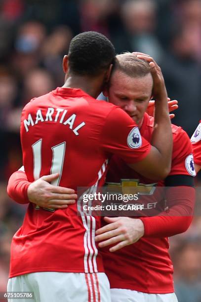 Manchester United's English striker Wayne Rooney celebrates scoring the opening goal during the English Premier League football match between...