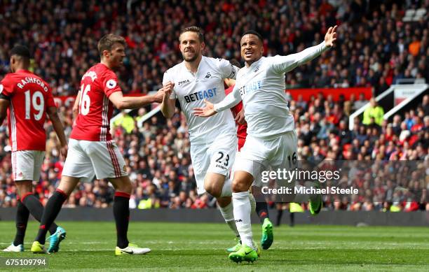 Gylfi Sigurdsson of Swansea City celebrates scoring his sides first goal with Martin Olsson of Swansea City during the Premier League match between...