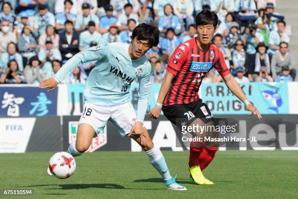 Koki Ogawa of Jubilo Iwata controls the ball under pressure of Kim Min Tae of Consadole Sapporo during the J.League J1 match between Jubilo Iwata and...