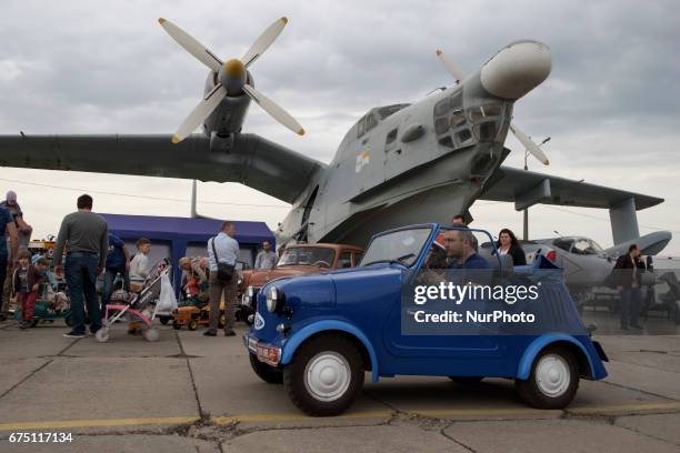 Visitor looks on an old car during the 'OldCarLand' motor show in Kyiv, Ukraine, 29 April 2017. About 900 old and exclusive cars , buses and...