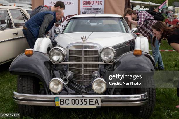 Visitor looks on an old car during the 'OldCarLand' motor show in Kyiv, Ukraine, 29 April 2017. About 900 old and exclusive cars , buses and...