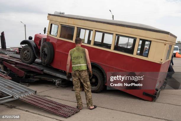 Visitor looks on an old car during the 'OldCarLand' motor show in Kyiv, Ukraine, 29 April 2017. About 900 old and exclusive cars , buses and...