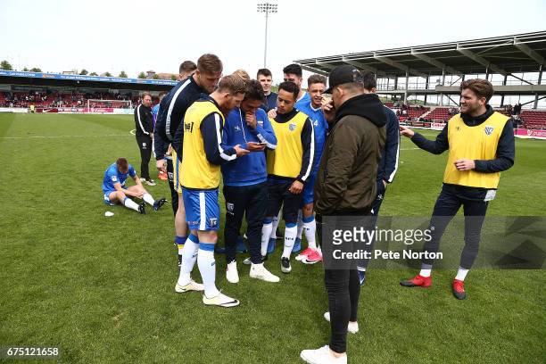 Gillingham players await the result of Fleetwood Town v Port Vale to avoided relegation at the end of the Sky Bet League One match between...