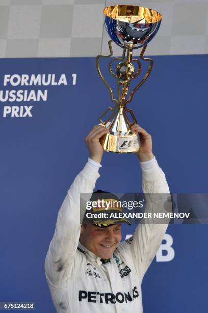 Mercedes' Finnish driver Valtteri Bottas celebrates on the podium after winning the Formula One Russian Grand Prix at the Sochi Autodrom circuit in...