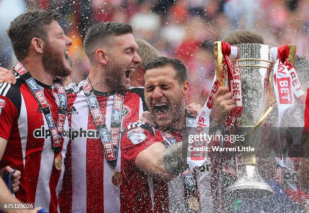 Billy Sharp, Captain of Sheffield United raises the Sky Bet League One trophy and celebrates winning promotion into next seasons Sky Bet Championship...