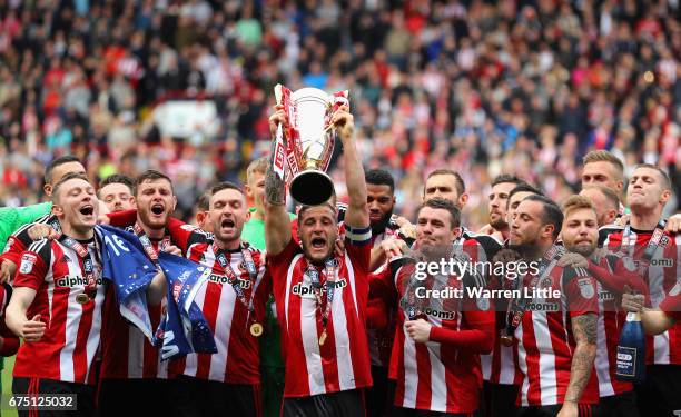 Billy Sharp, Captain of Sheffield United raises the Sky Bet League One trophy and celebrates winning promotion into next seasons Sky Bet Championship...