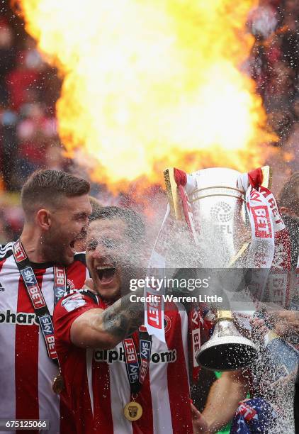 Billy Sharp, Captain of Sheffield United raises the Sky Bet League One trophy and celebrates winning promotion into next seasons Sky Bet Championship...