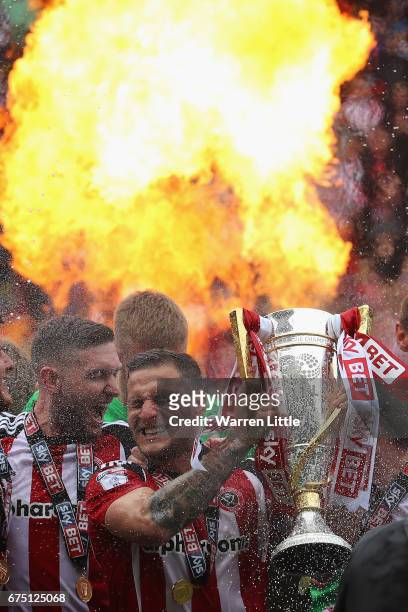 Billy Sharp, Captain of Sheffield United raises the Sky Bet League One trophy and celebrates winning promotion into next seasons Sky Bet Championship...