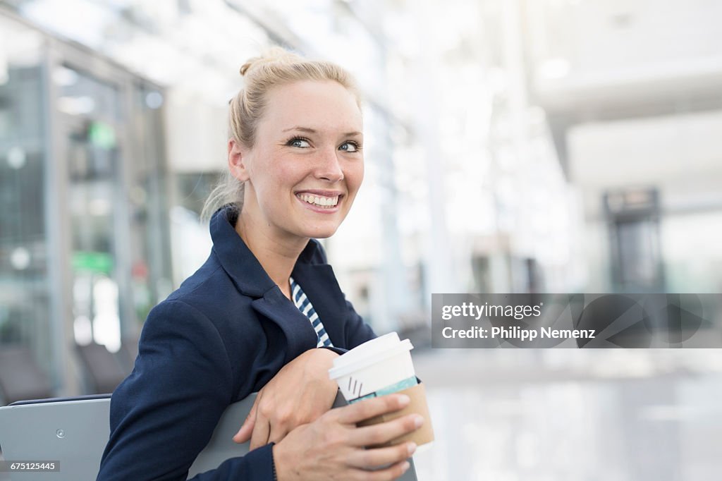 Women on airport with coffee