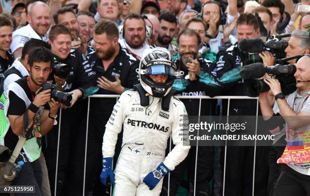 Mercedes' Finnish driver Valtteri Bottas celebrates with the team's crew after winning the Formula One Russian Grand Prix at the Sochi Autodrom...