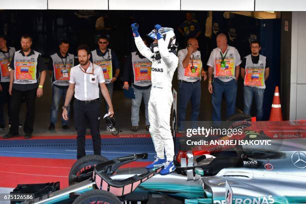 Mercedes' Finnish driver Valtteri Bottas celebrates with the team's crew after winning the Formula One Russian Grand Prix at the Sochi Autodrom...