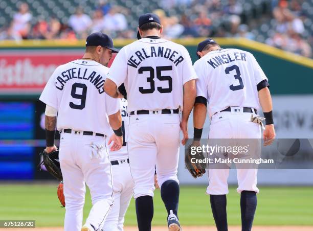 Nicholas Castellanos, Justin Verlander and Ian Kinsler of the Detroit Tigers stand together on the field during the game against the Boston Red Sox...