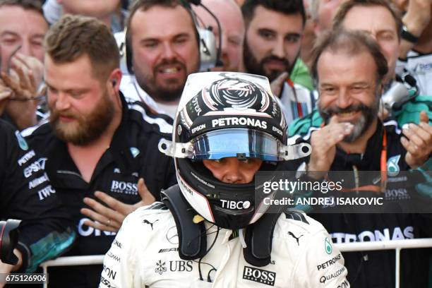 Mercedes' Finnish driver Valtteri Bottas celebrates with the team's crew after winning the Formula One Russian Grand Prix at the Sochi Autodrom...