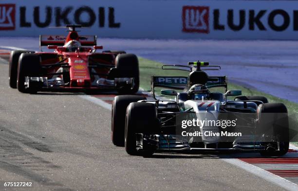 Valtteri Bottas driving the Mercedes AMG Petronas F1 Team Mercedes F1 WO8 leads Sebastian Vettel of Germany driving the Scuderia Ferrari SF70H on...