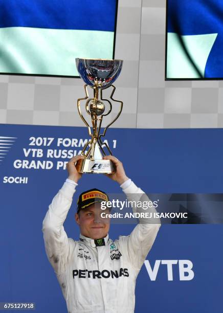 Mercedes' Finnish driver Valtteri Bottas celebrates on the podium after winning the Formula One Russian Grand Prix at the Sochi Autodrom circuit in...