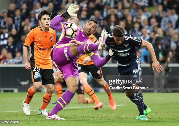 Goalkeeper Jamie Young of the Roar makes a save as Marco Rojas of the Victory competes for the ball during the A-League Semi Final match between...